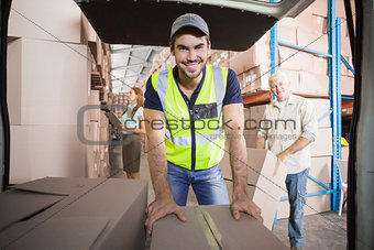 Delivery driver loading his van with boxes