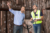 Warehouse manager talking with worker