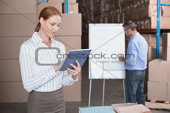 Warehouse manager working on tablet pc