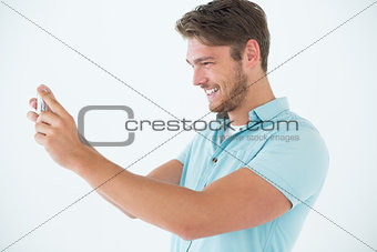 Happy man looking at his mobile phone