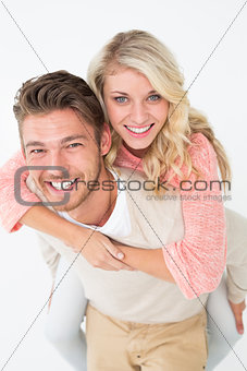 Portrait of a man piggybacking woman