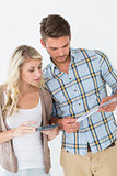 Concentrated young couple with bills and calculator