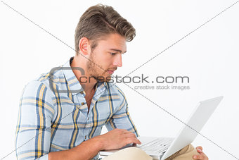 Attractive young man using laptop