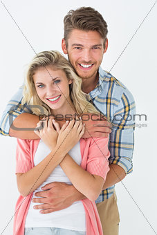 Young man embracing woman from behind