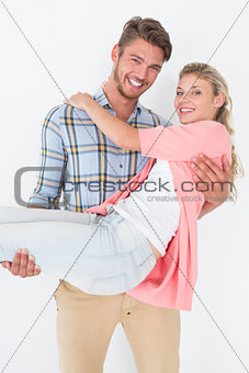 Young man carrying cheerful woman
