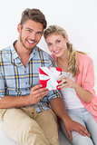 Attractive young couple holding gift