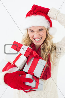 Santa woman scratching head and holding gifts