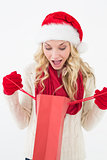 Shocked santa woman looking into shopping bag