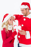 Attractive young couple wearing santa hats with gift