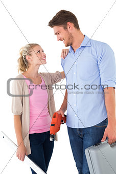 Attractive young couple holding diy tools