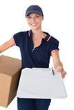 Delivery woman holding cardboard box and clipboard