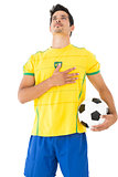 Brazilian football player listening to anthem