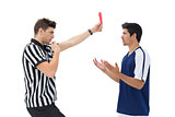 Referee showing red card to football player