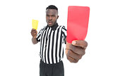 Serious referee showing yellow and red card