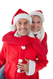happy mature couple wearing santa hats