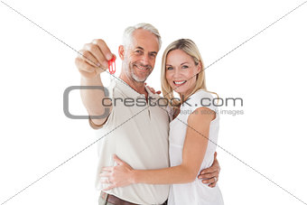 Happy mature couple holding new house key