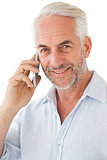 Smiling mature man using mobile phone