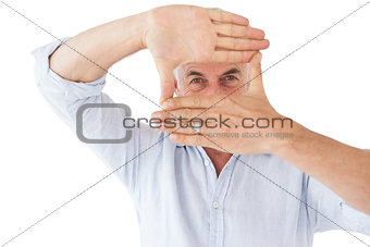 Mature man making frame with his hands