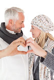 Mature couple forming heart with hands