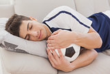 Football fan sleeping with ball