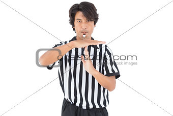 Serious referee showing time out sign