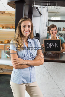 Pretty waitress and customer smiling at camera