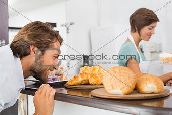 Handsome customer eyeing up plate of croissants