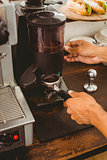 Barista grinding fresh coffee beans