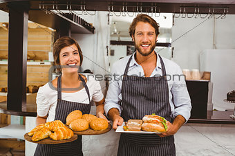 Happy servers holding plates of food