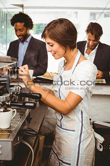 Pretty barista making cup of coffee