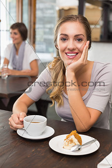 Pretty blonde enjoying cake and coffee