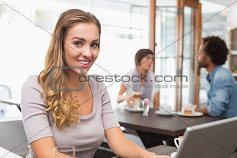 Pretty blonde using her laptop