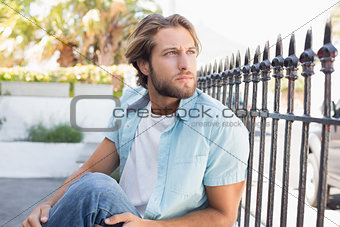 Casual man sitting and thinking