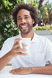 Smiling man having a coffee