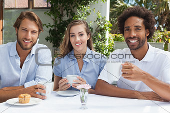 Happy friends enjoying coffee together