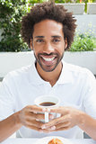 Smiling man having a coffee
