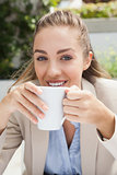 Beautiful businesswoman enjoying a coffee
