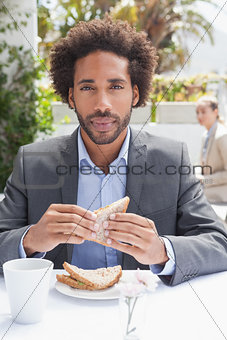 Businessman having sandwich for lunch