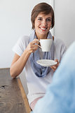 Casual woman having a coffee with friend