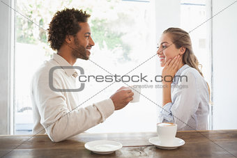 Happy couple on a date having coffee