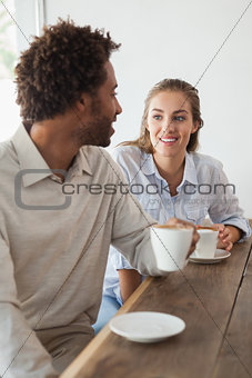 Happy couple on a date having coffee