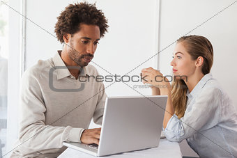 Happy couple on a date using laptop