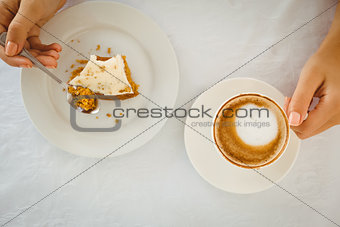 Woman having cake and coffee