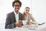 Business people having coffee smiling at camera