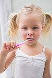 Cute girl brushing her teeth