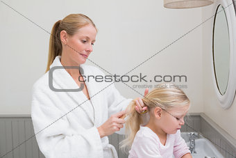 Happy mother and daughter getting ready