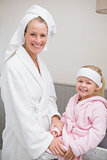 Cute little girl with mother in bathrobes