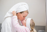 Cute little girl with mother in bathrobes