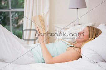 Happy blonde reading her book