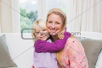 Happy mother and daughter on the couch